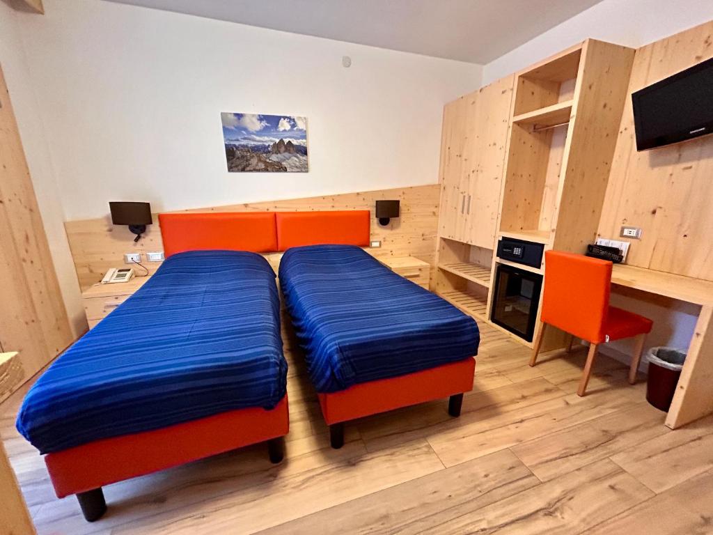 Łóżko lub łóżka w pokoju w obiekcie Hotel Centrale