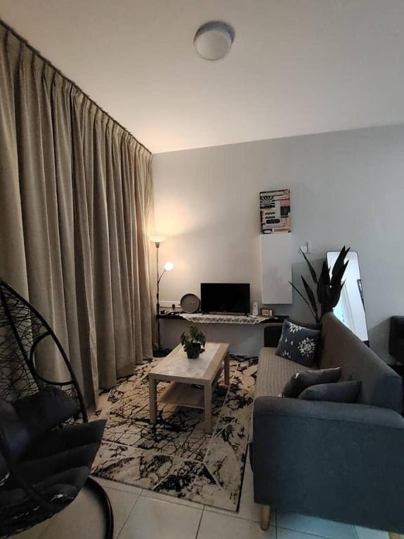 a living room with a couch and a table at AzzSpacesAnderson in Ipoh