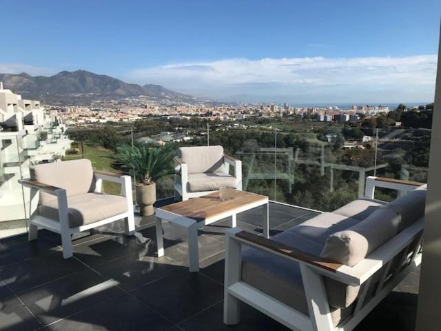 a group of chairs and a table on a balcony at De Droomhacienda in Fuengirola