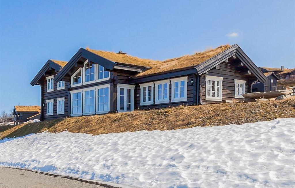 a house sitting on top of a pile of snow at Stunninng Home In Rauland With Sauna in Rauland