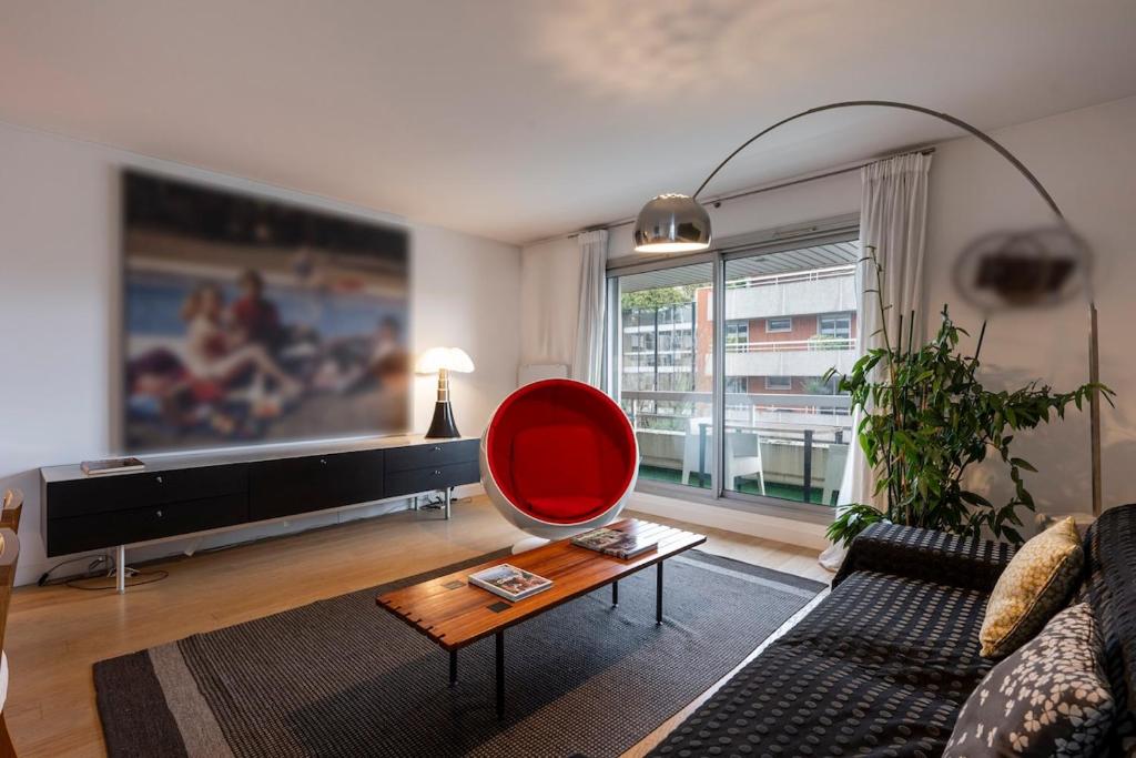 - un salon avec un canapé et un fauteuil rouge dans l'établissement Elegant 100m2 apartment, à Boulogne-Billancourt