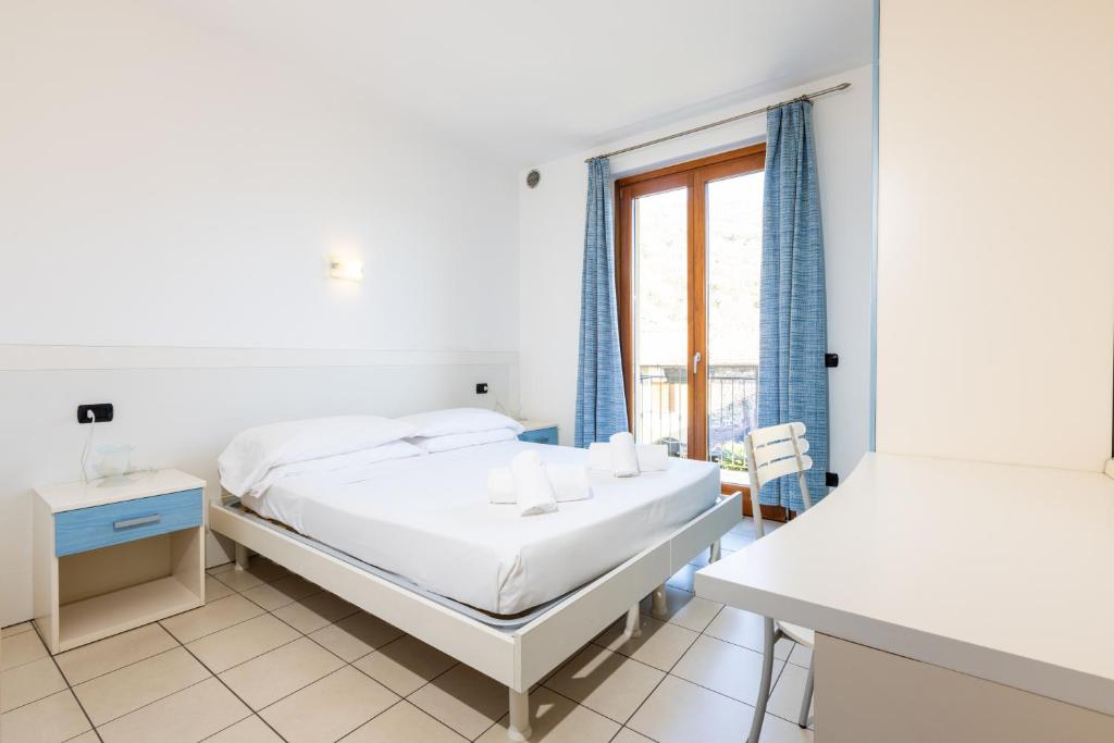 Postel nebo postele na pokoji v ubytování Spluga "Relax & Apartaments" by Alfio Colombo