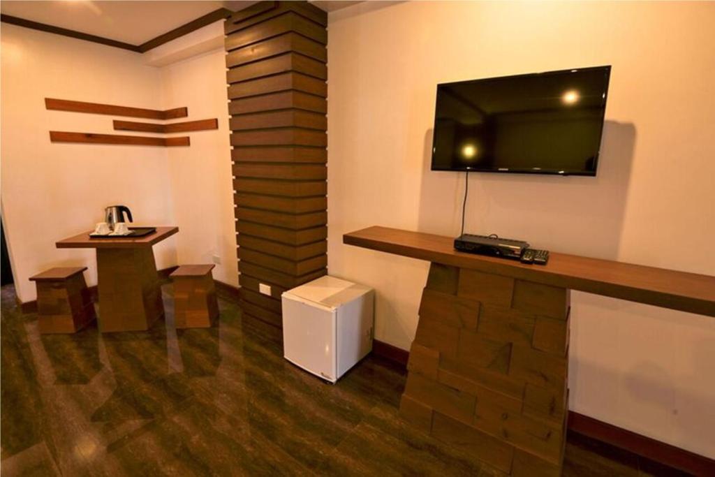 Televízia a/alebo spoločenská miestnosť v ubytovaní Abozza Resort