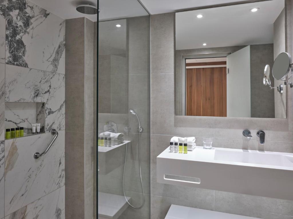 a bathroom with a shower and a sink at Atlantica Sungarden Park in Ayia Napa
