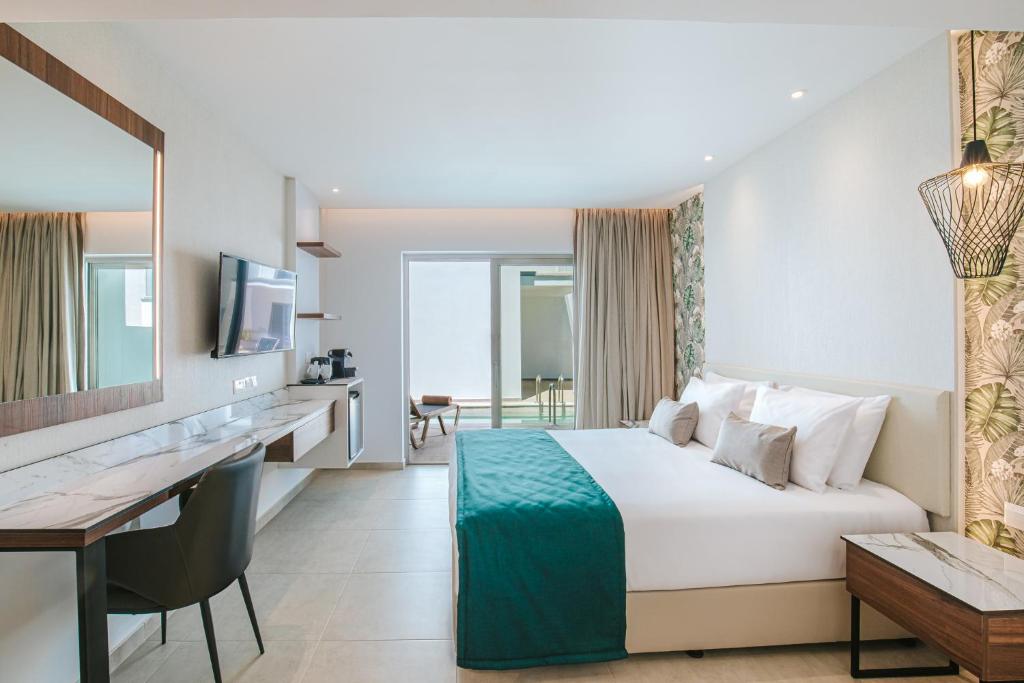 a hotel room with a bed and a desk at Atlantica Sungarden Park in Ayia Napa