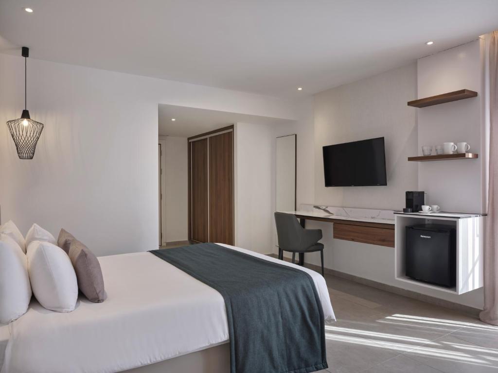 a hotel room with a bed and a desk at Atlantica Sungarden Park in Ayia Napa