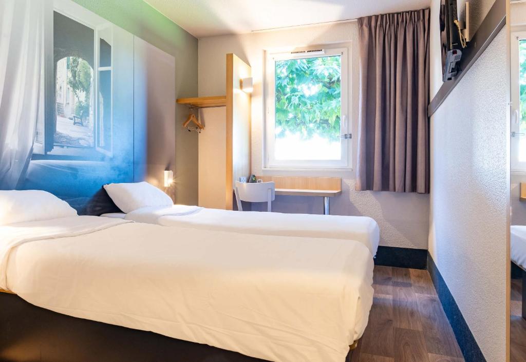 Postel nebo postele na pokoji v ubytování B&B HOTEL Valence Sud