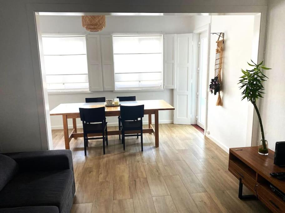 a living room with a dining room table and chairs at Alfazema Alojamento Local in Angra do Heroísmo