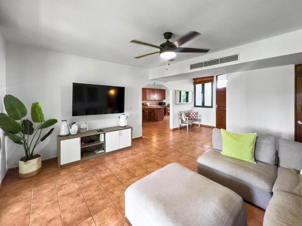 a living room with a couch and a flat screen tv at Rio Mar Village Beach Apt for Families and Groups in Rio Grande