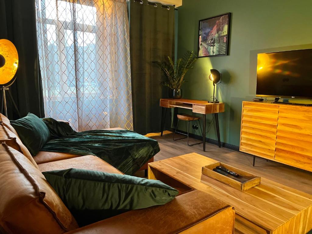 a living room with a couch and a tv at Apartment Riga Purvciems in Rīga