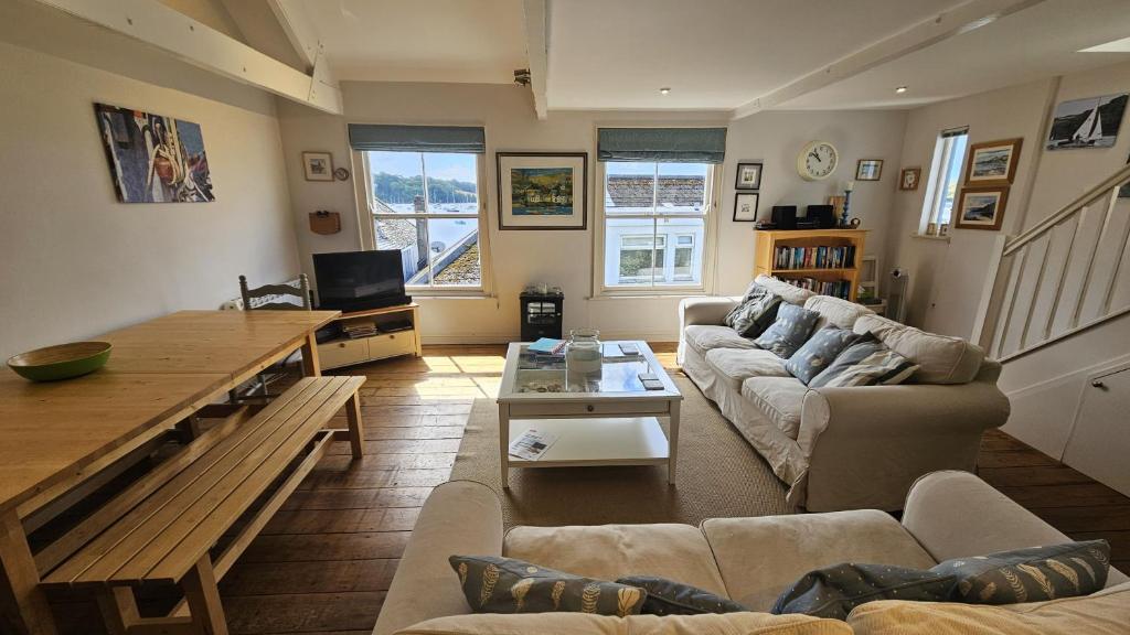 a living room with a couch and a table at Workshop in Saint Mawes