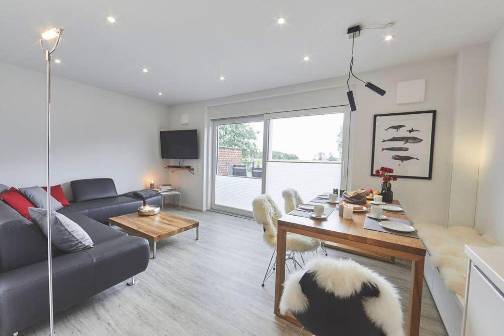 a living room with a couch and a table at Treibgut in Norddeich