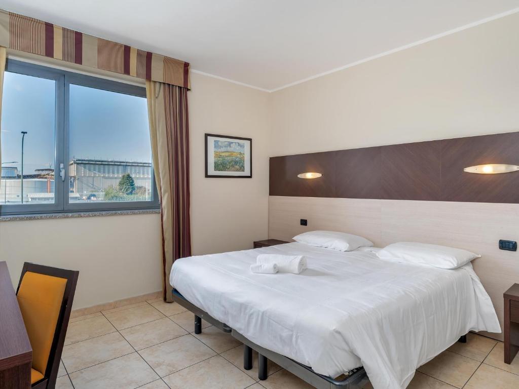 Postel nebo postele na pokoji v ubytování B&B HOTEL Settimo Torinese