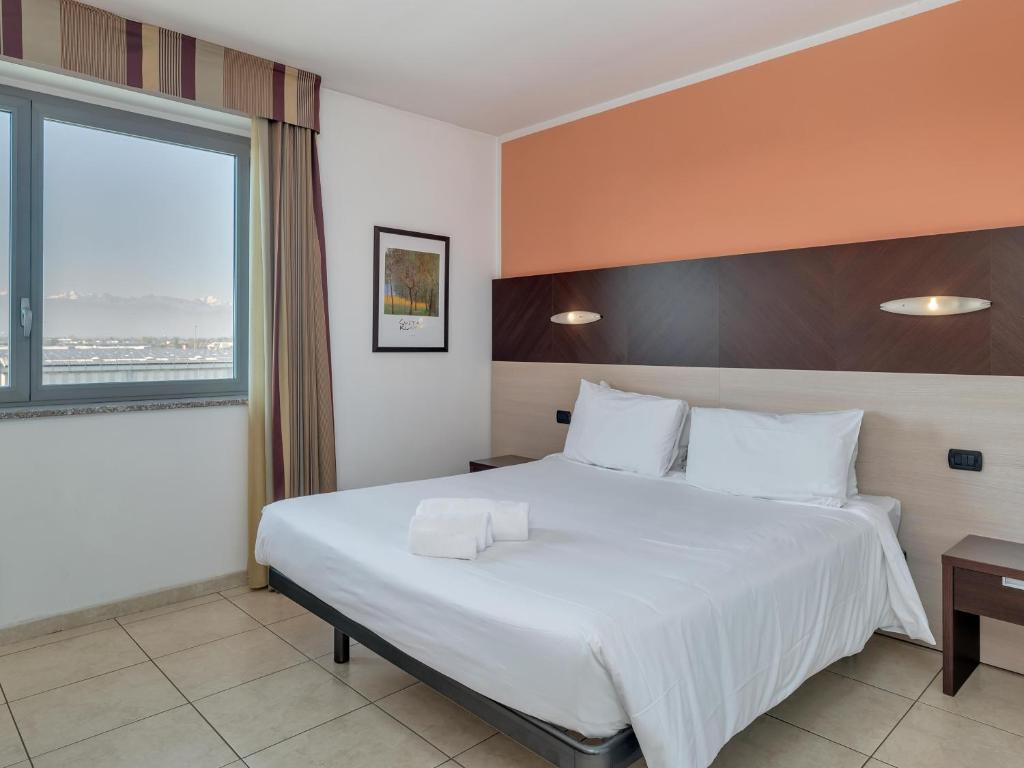 Postel nebo postele na pokoji v ubytování B&B HOTEL Settimo Torinese