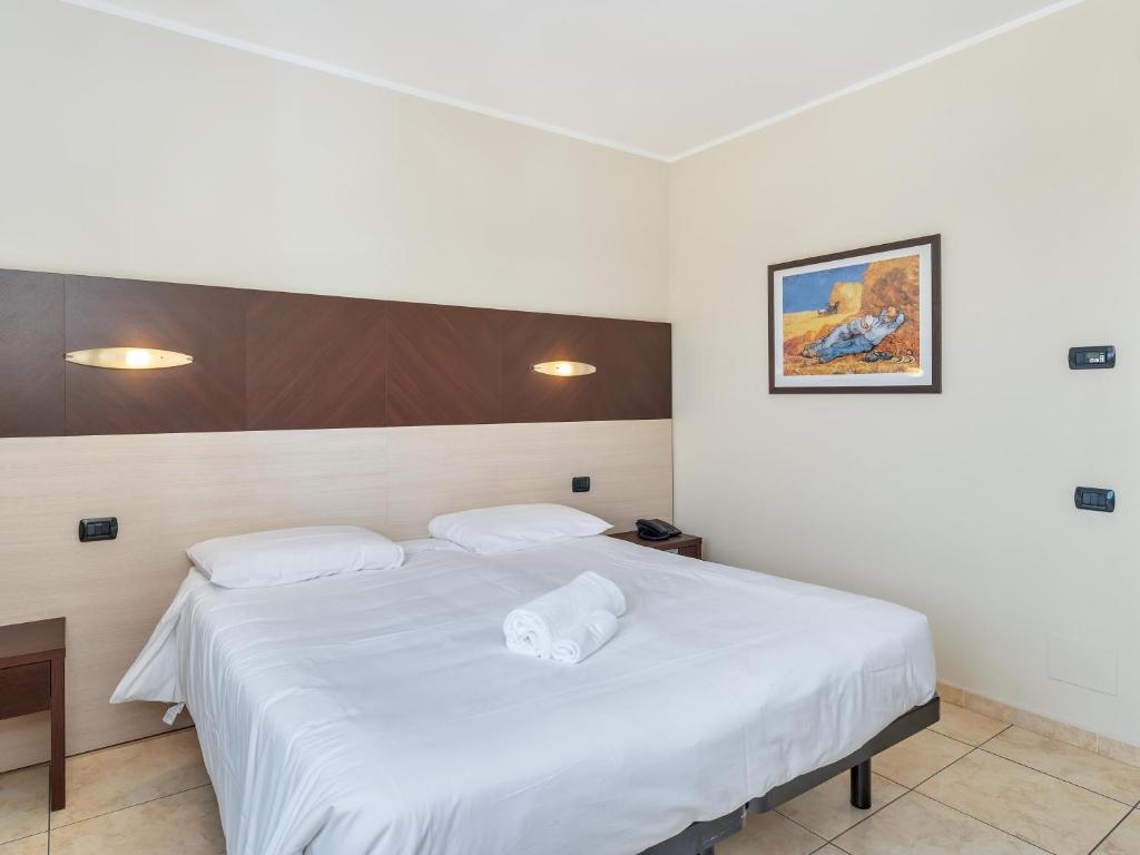 Postel nebo postele na pokoji v ubytování B&B HOTEL Settimo Torinese