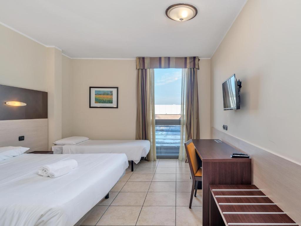 Postel nebo postele na pokoji v ubytování B&B HOTEL Settimo Torinese