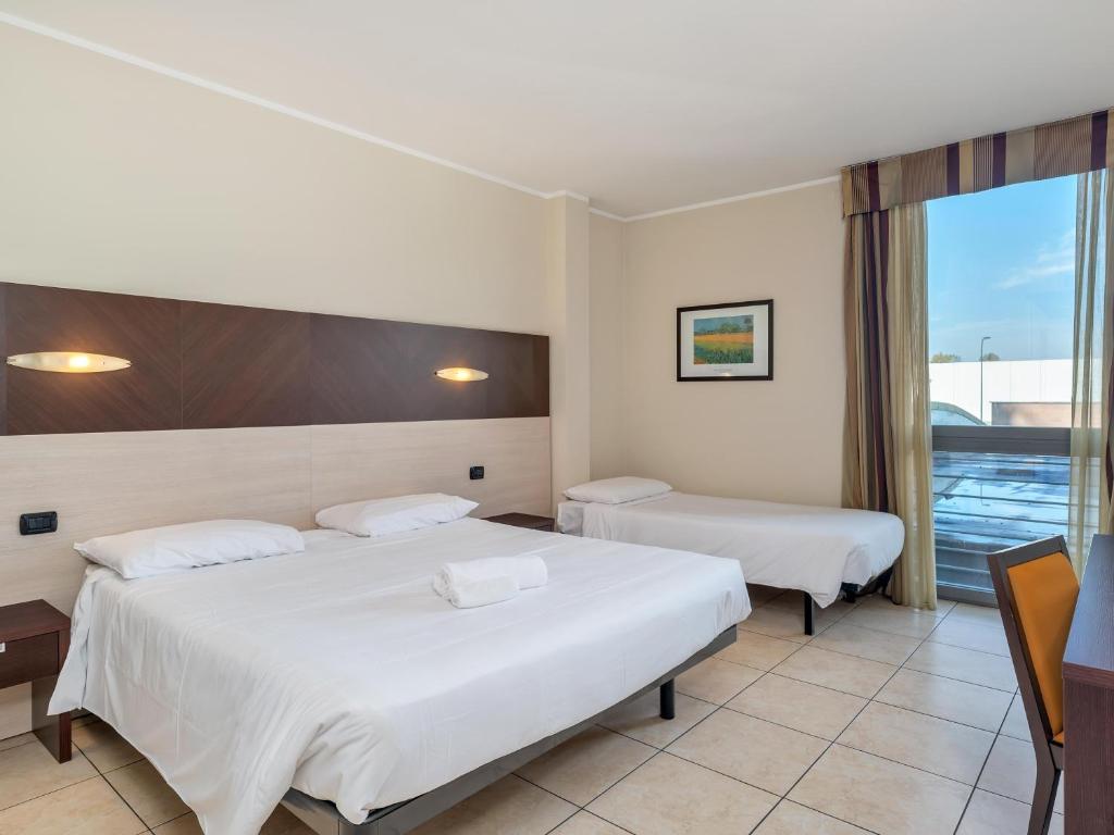 Postel nebo postele na pokoji v ubytování B&B HOTEL Settimo Torinese