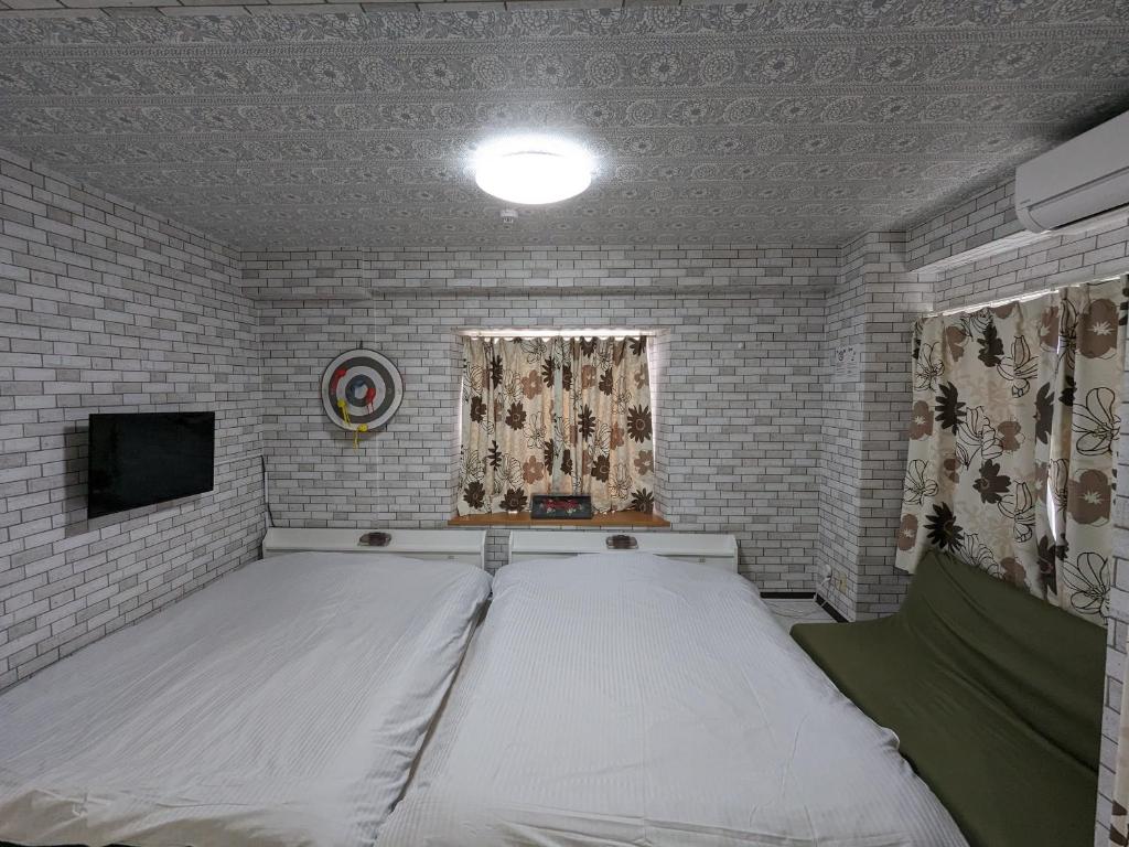 Postel nebo postele na pokoji v ubytování Koganeno mori heights