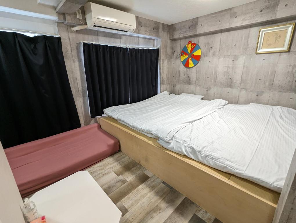 Postel nebo postele na pokoji v ubytování Koganeno mori heights