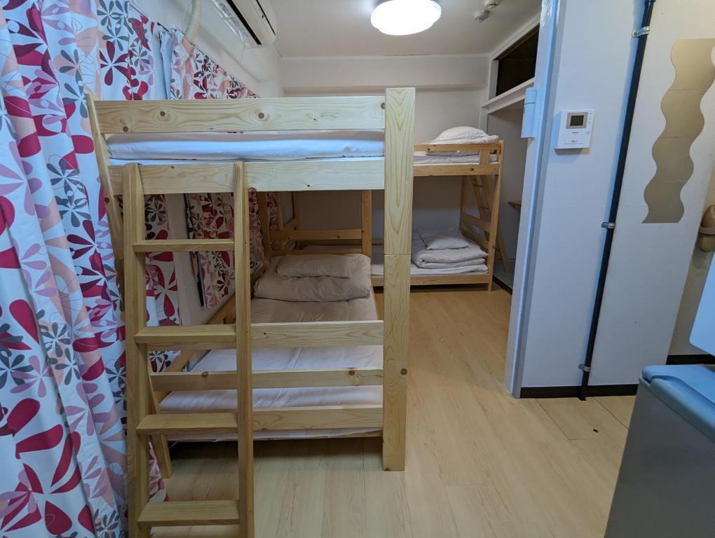 Postel nebo postele na pokoji v ubytování Koganeno mori heights
