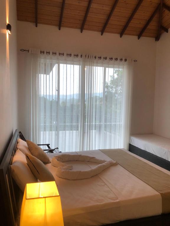 Postel nebo postele na pokoji v ubytování Chathu Holiday Home