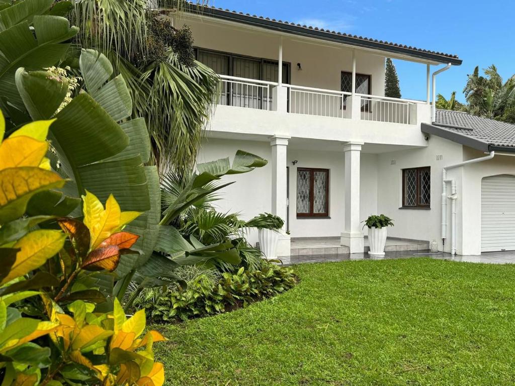 Una casa con un césped verde delante de ella. en Private House with Pool, en Southbroom