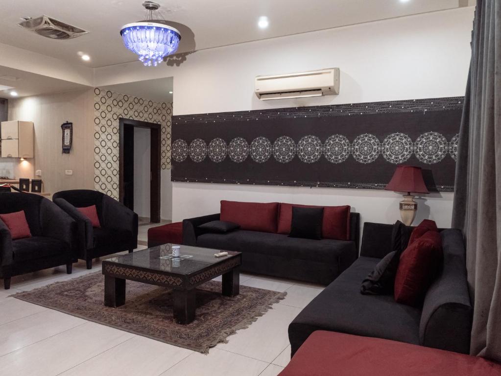 a living room with couches and a coffee table at Family Comfort Suites in Rawalpindi
