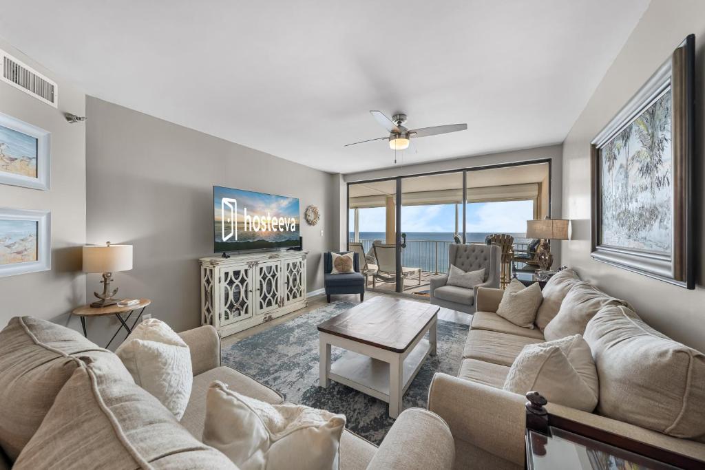a living room with a couch and a tv at Bluewater Vacation Rentals in Orange Beach