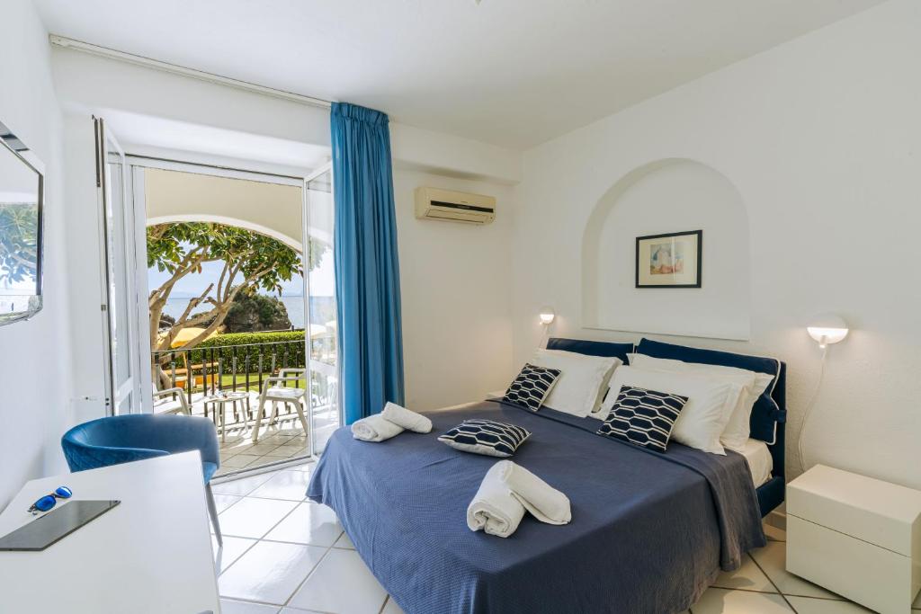 Ένα ή περισσότερα κρεβάτια σε δωμάτιο στο Gardenia Mare Apartments