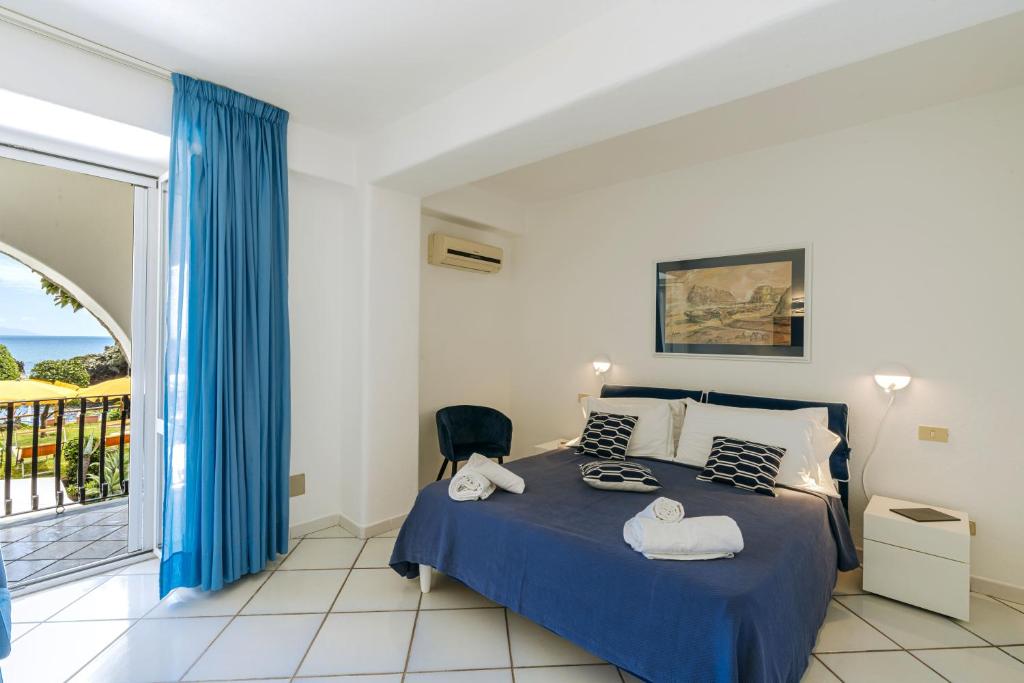 Ένα ή περισσότερα κρεβάτια σε δωμάτιο στο Gardenia Mare Apartments