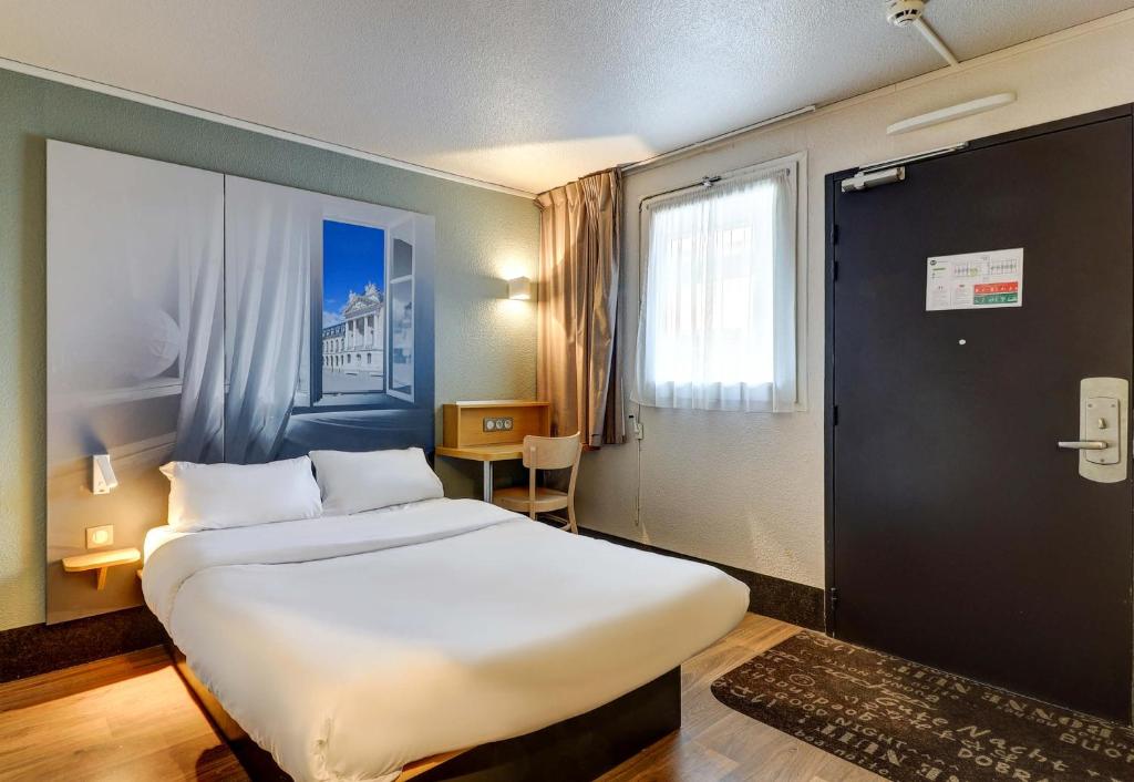 Postel nebo postele na pokoji v ubytování B&B HOTEL Dijon Marsannay