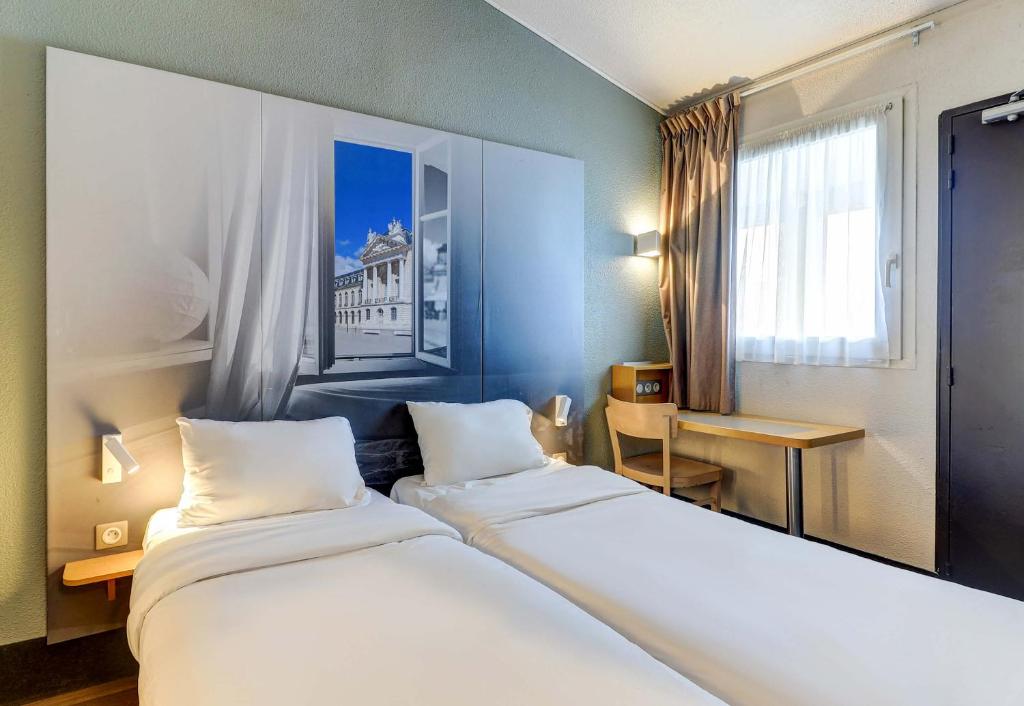 Postel nebo postele na pokoji v ubytování B&B HOTEL Dijon Marsannay