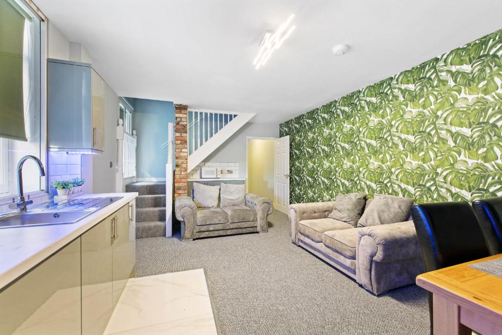 a living room with a couch and a kitchen at Still House in Boston