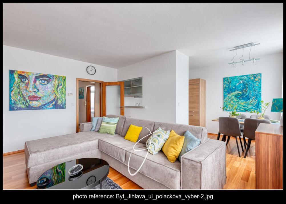 a living room with a couch and a dining room at Apartmán Poláčkova in Jihlava