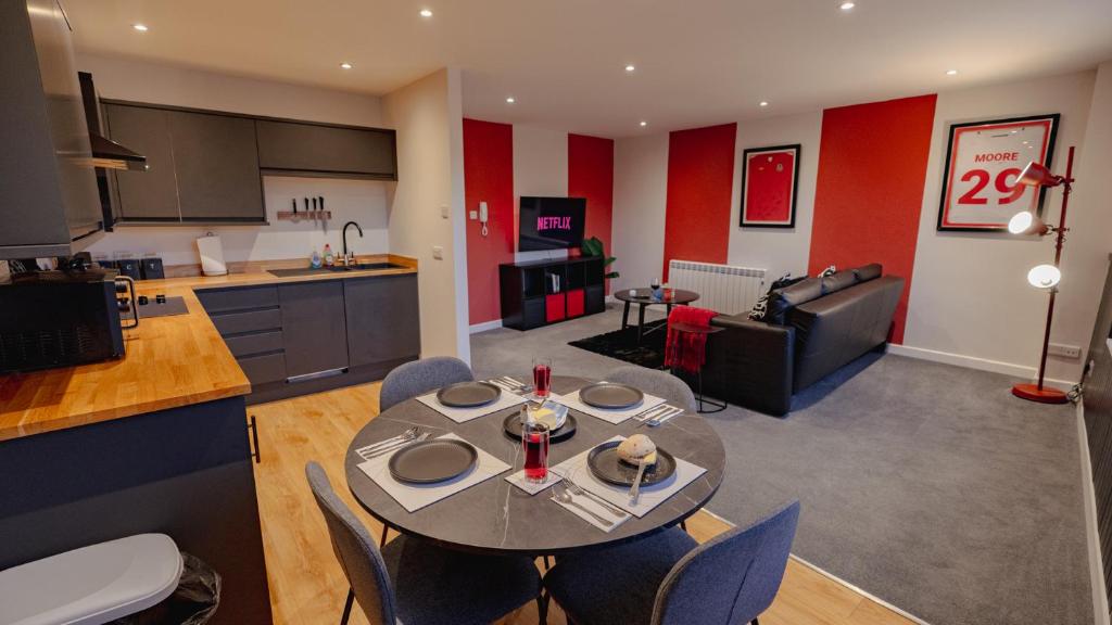 a kitchen and living room with a table and chairs at Cardiff City Centre - Luxury Apartments in Cardiff