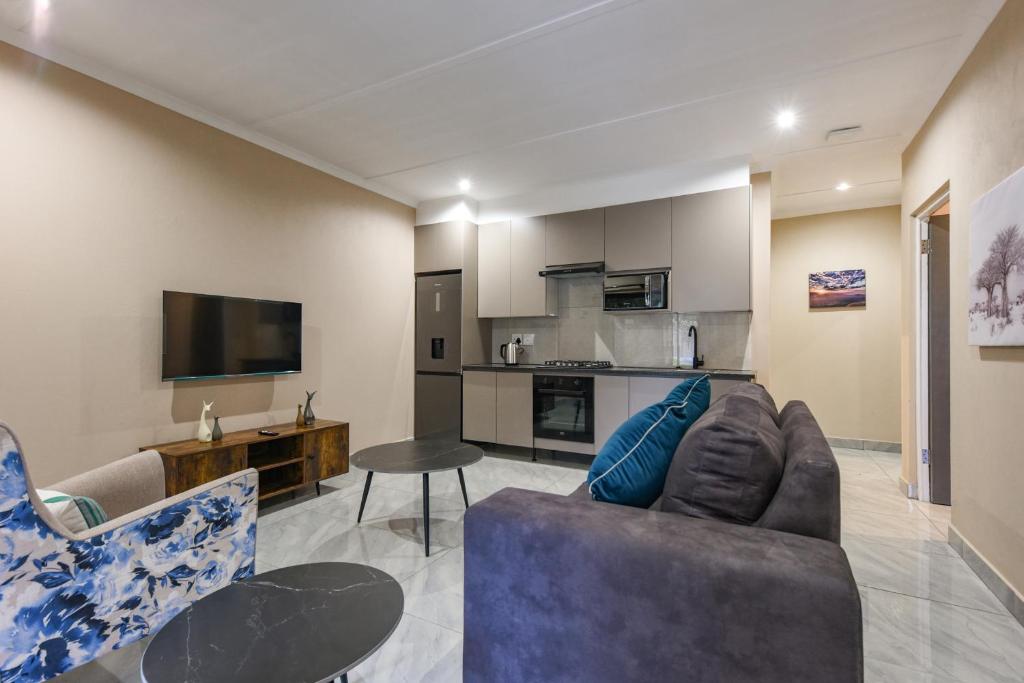a living room with a couch and a table at Serenity Amarula in Sandton