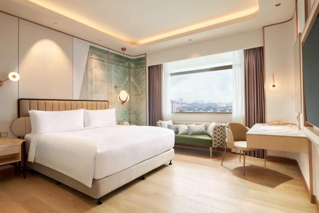 Postel nebo postele na pokoji v ubytování Hilton Petaling Jaya