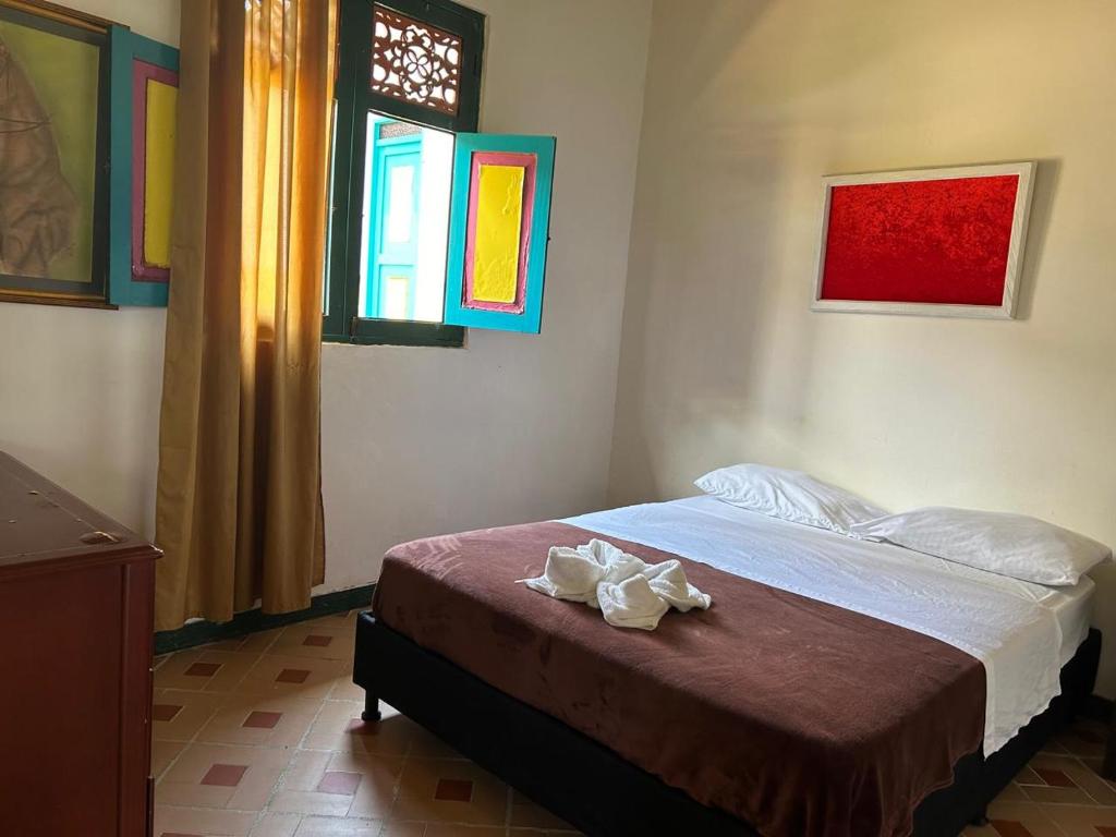 Postel nebo postele na pokoji v ubytování FINCA HOTEL TRADICION CAFETERA