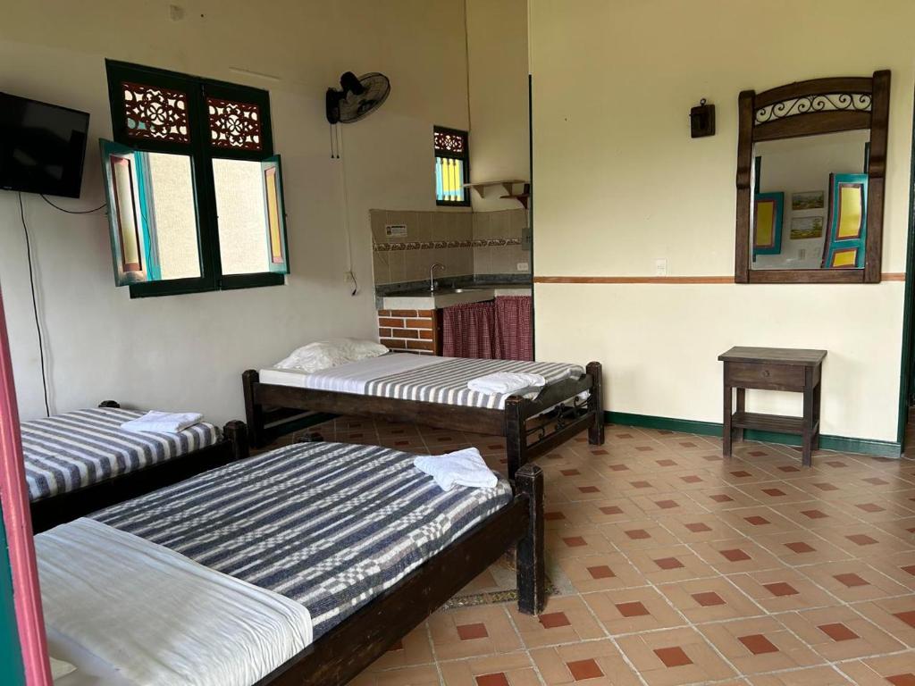 Postel nebo postele na pokoji v ubytování FINCA HOTEL TRADICION CAFETERA