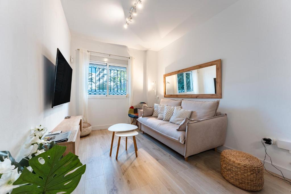 a living room with a couch and a table at Martin´s Place 80 Mts To Beach in Fuengirola