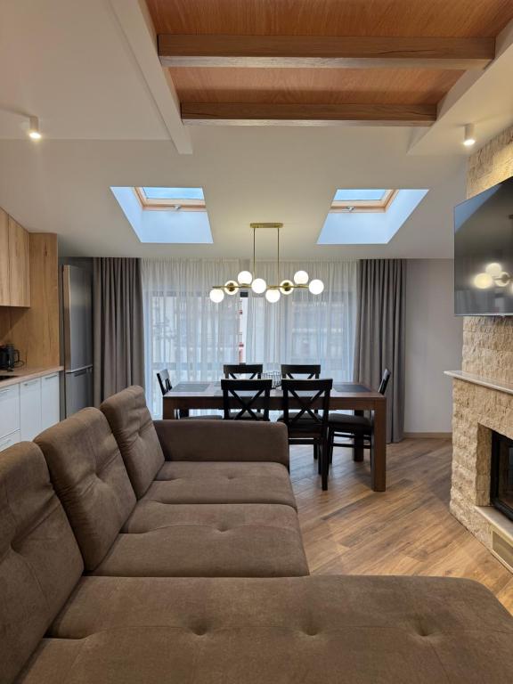 a living room with a couch and a dining room at Апарт Злата in Bukovel
