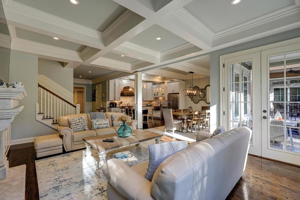 a living room with a couch and a table at New Listing 5 BR Luxury Beach Home w Private Pool Three Master Suites Granite in Hilton Head Island