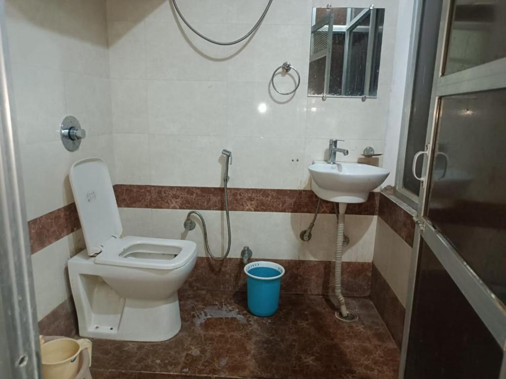 a bathroom with a toilet and a sink at Bagol Palace in Udaipur