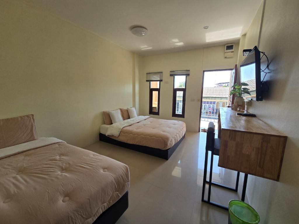 Postel nebo postele na pokoji v ubytování เสม็ด โฮเทล Samed Hotel