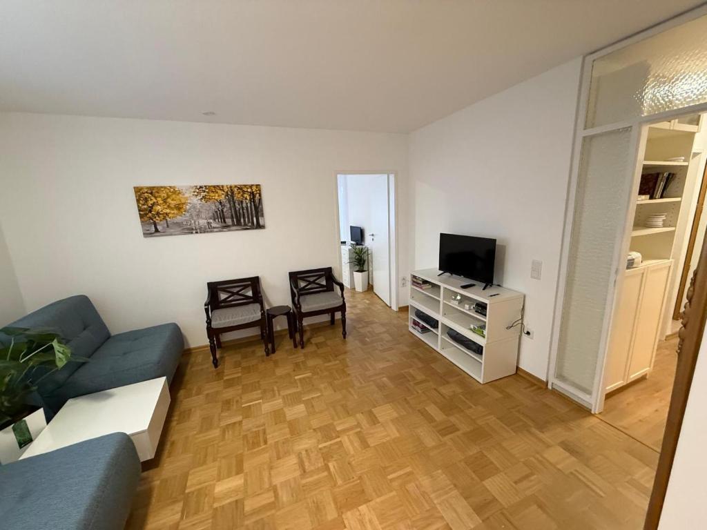 a living room with a couch and a tv at Ferienwohnung-Montagewohnung 1 in Paderborn