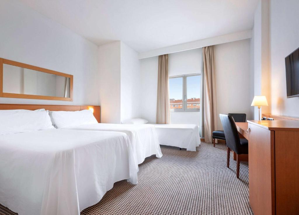 Postel nebo postele na pokoji v ubytování Hotel Zentral León