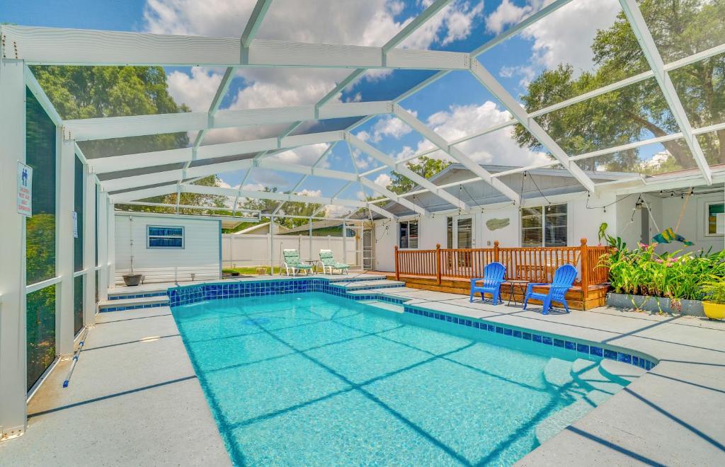 a swimming pool in a house with a glass ceiling at Ocala Retreat with Pool, Grill and Yard - Pets Welcome in Ocala