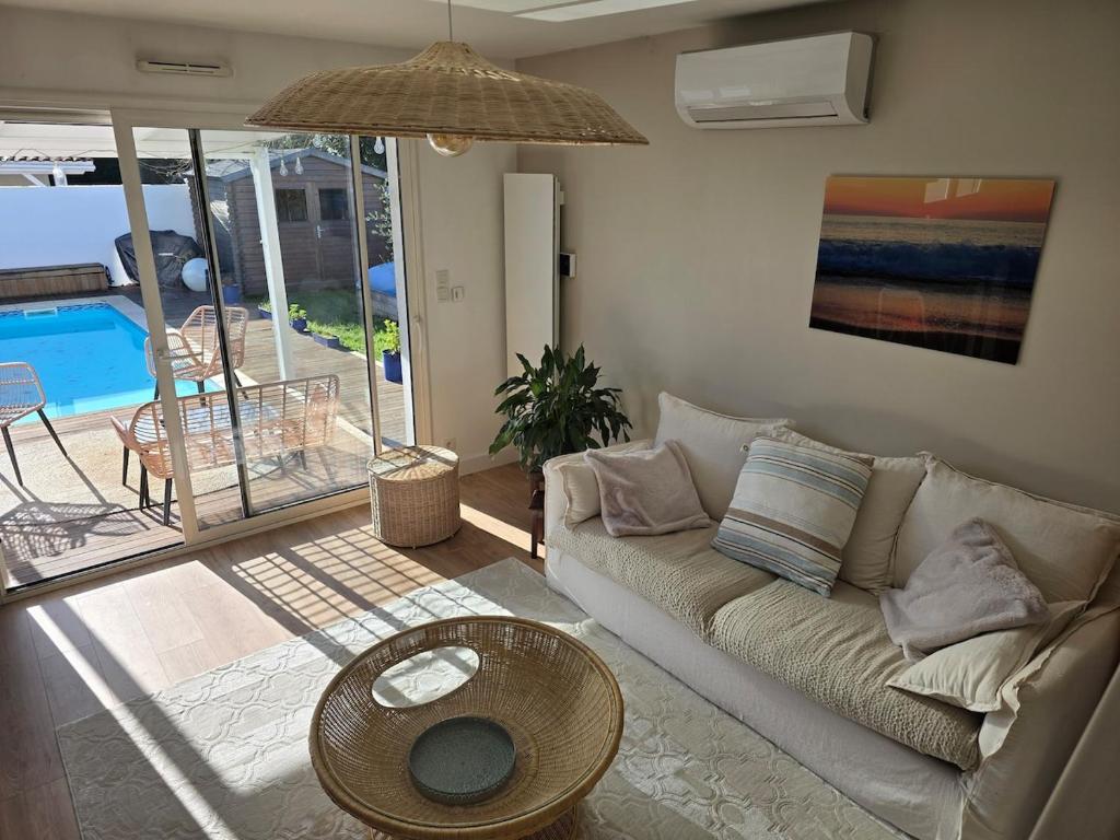 Maison au calme avec piscine في سان ميدارد-أون-جال: غرفة معيشة بها أريكة وطاولة