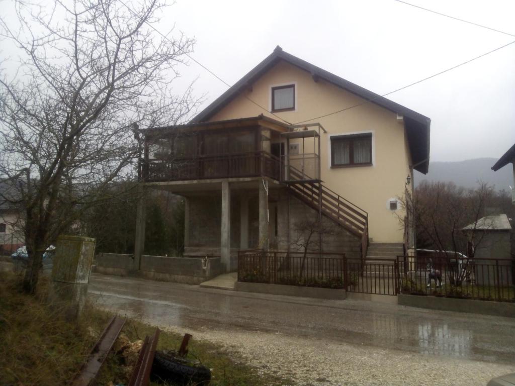 a house with a balcony on the side of it at studio SM IK 3 in Tomislavgrad