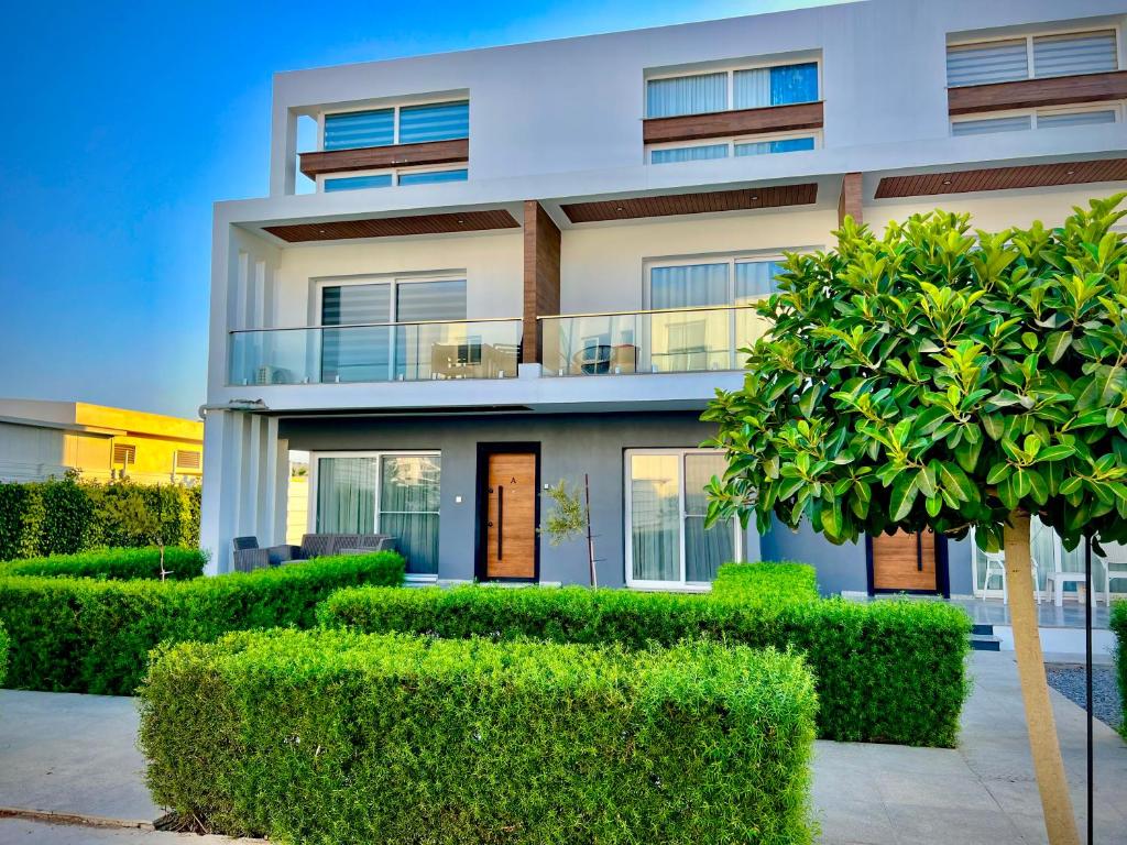 a house with bushes in front of it at 4Seasons Ciprus 1+1 in Boğaz